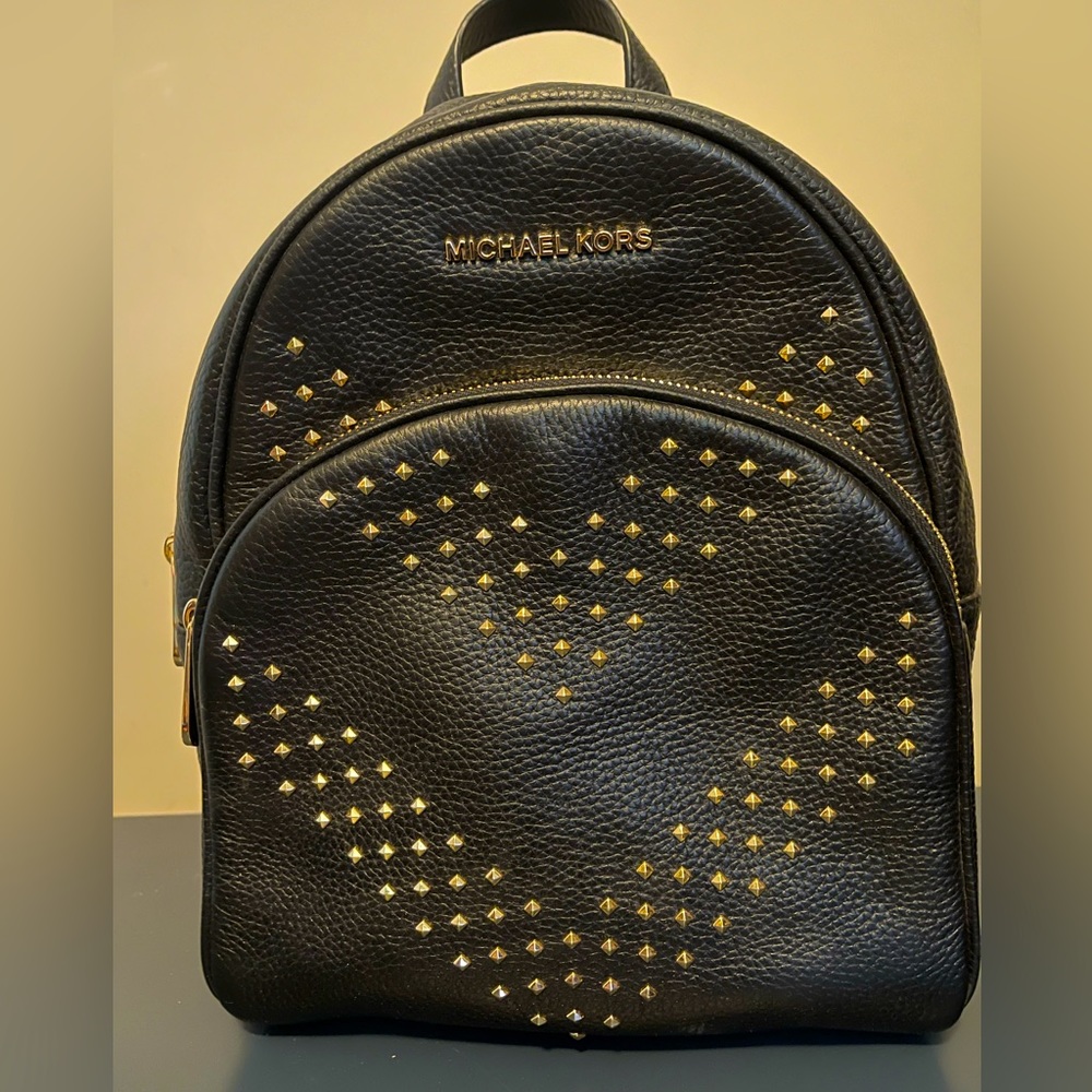 Michael Kors black leather backpack never used with gold studs. Pristine conditi